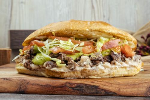Asada Torta with grilled beef, fresh vegetables, and a toasted bun